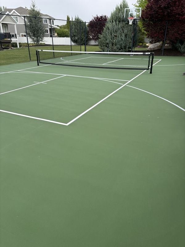 Green Multi-Sport Backyard Court with Tennis, Pickleball and Basketball Lines by Precision Pro Courts